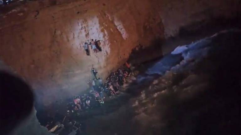 This screen grab from a video made available on October 6, 2022 by the Hellenic Coast Guard, shows the rescue of migrants from a shipwreck off the island of Cythera, south of the Peloponnese peninsula. Greece’s coastguard reports it has recovered the bodies of 15 people in two separate migrant boat sinkings, with several more feared missing. There was no official toll yet from a second sinking south of the Peloponnese peninsula. AFPPIX