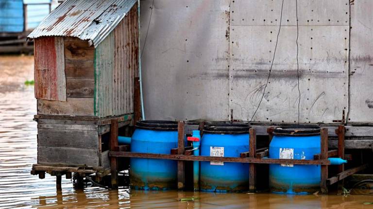 This photo taken on March 13, 2023 shows floating toilets in Chong Prolay village on Tonle Sap lake in Siem Reap province. AFPPIX