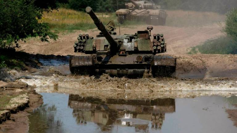The Polish tank PT-91, a newer model of the Soviet tank T-72, drives through water at the military base in Bedrusko near Poznan, western Poland, July 9, 2013. REUTERSPIX
