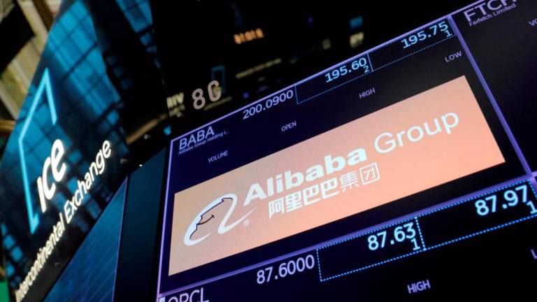 The logo of Alibaba Group is seen on the trading floor at the New York Stock Exchange. Alibaba says it will work to maintain its New York Stock Exchange listing alongside its Hong Kong listing – Reuterspix