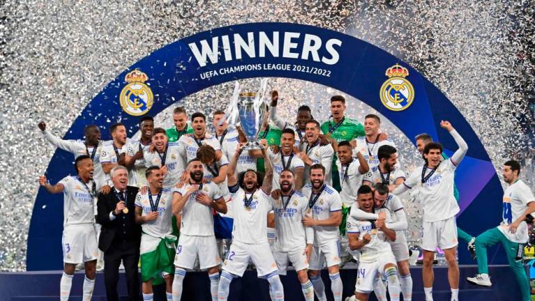 Real Madrid's Brazilian defender Marcelo lifts the Champions League trophy after Madrid 's victory in the UEFA Champions League final football match between Liverpool and Real Madrid at the Stade de France in Saint-Denis, north of Paris, on May 28, 2022. AFPpix