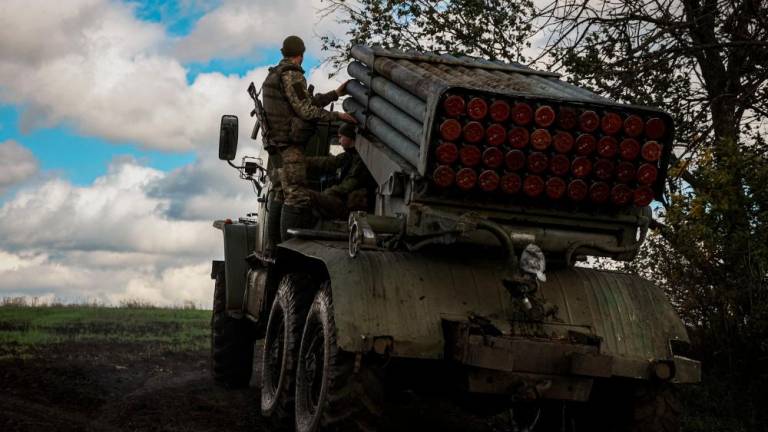 A crew of BM-21 'Grad' multiple rocket launcher move down a road at a position along the front line in Donetsk region on October 3, 2022, amid the Russian invasion of Ukraine. - AFPPIX