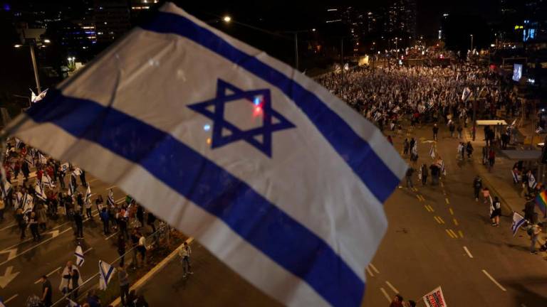 People waving Israel’s national flag take part in a protest in Tel Aviv, against the government’s controversial judicial overhaul bill, on March 25, 2023. AFPPIX