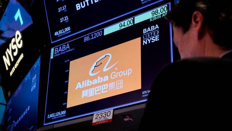 A trader working at the post where Alibaba is traded on the floor of the New York Stock Exchange ypday (March 28). – Reuterspic