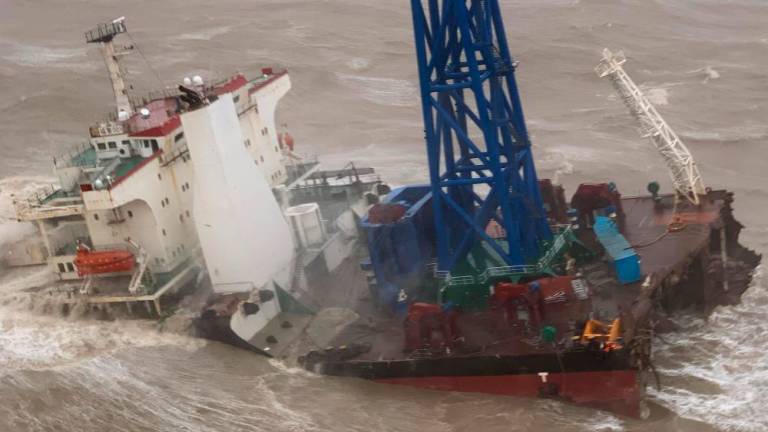 his handout photo taken and released by the Hong Kong Government Flying Service on July 2, 2022 shows a ship after it broke into two amid Typhoon Chaba, during a rescue operation of the crew members in the South China Sea 160 nautical miles southwest of Hong Kong. AFPPIX