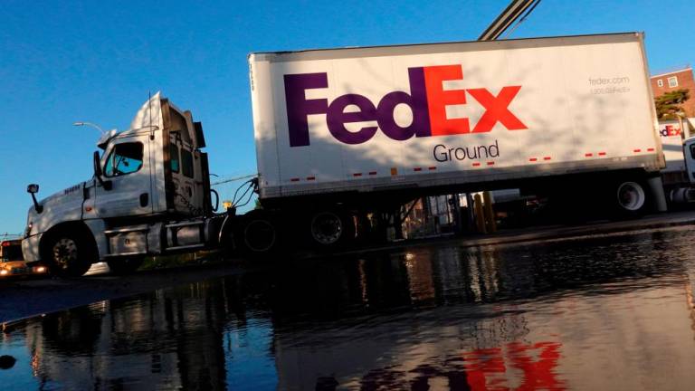 A FedEx delivery truck exits a facility in Brooklyn, New York City. FedEx plans to raise average rates by 6.9% starting on Jan 2. – Reuterspix