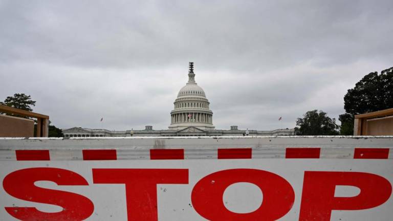 A traffic barrier is seen front of the dome of the US Capitol as a government shut down looms in Washington DC on September 28, 2023. AFPPIX