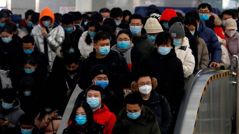 People wearing face masks commute in a subway station during morning rush hour, following the coronavirus disease ( Covid-19) outbreak, in Beijing, China January 20, 2021. REUTERSpix