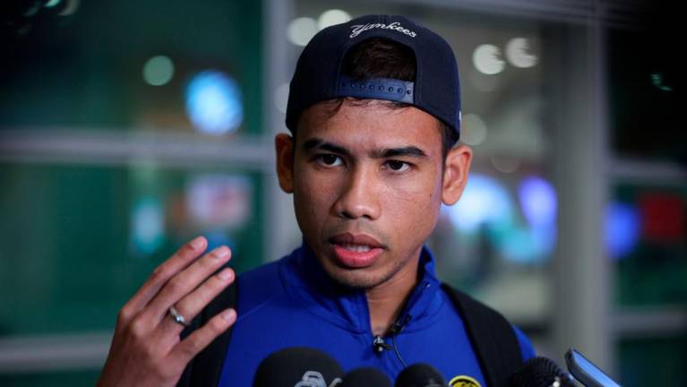 SEPANG, 26 Sept -- Harimau Malaya player Muhammad Safawi Rasid when met by reporters immediately after landing at Kuala Lumpur International Airport 2 (KLIA 2) at 9.30 last night. BERNAMAPIX