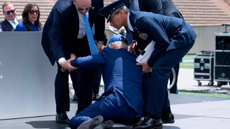 US President Joe Biden is helped up after falling during the graduation ceremony at the United States Air Force Academy, just north of Colorado Springs in El Paso County, Colorado, on June 1, 2023. AFPPIX