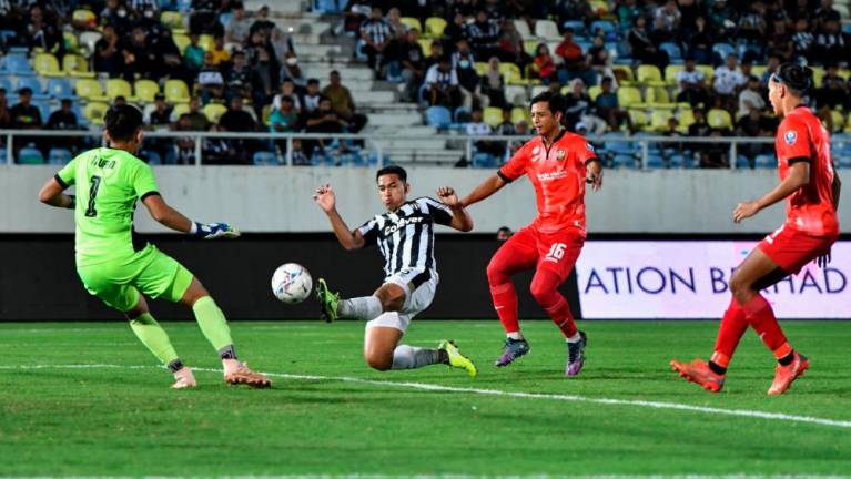 KUALA NERUS, 13 August -- Terengganu FC player Muhamad Shahrul Nizam Ros Hasni (second, left) is pushed by Sarawak United FC player Ahmad Tasnim Fitri Mohd Nasir while attempting a goal in the 2022 Super League at the Sultan Mizan Zainal Abidin Stadium in here last night BERNAMAPIX