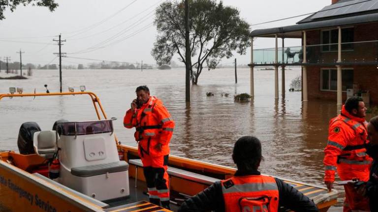 State Emergency Service (SES) personnel prepare to deploy as floodwaters submerge residential areas following heavy rains in the Windsor suburb of Sydney, Australia, July 5, 2022. REUTERSPIX