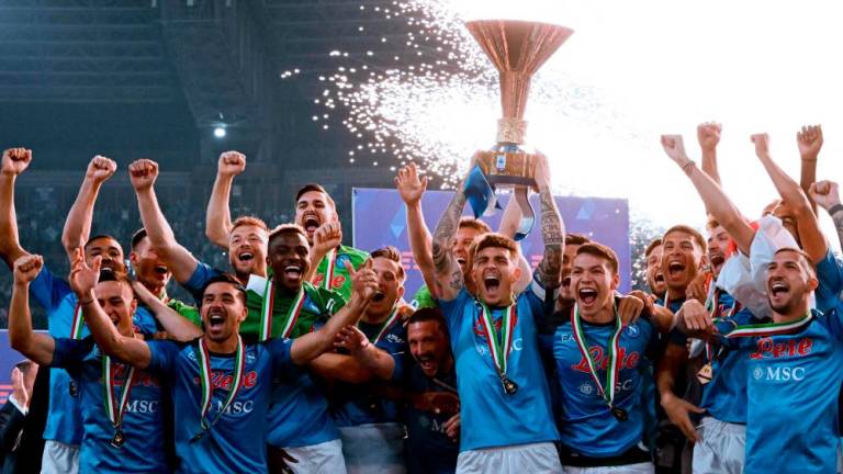 Napoli’s Italian defender Giovanni Di Lorenzo (C) holds the Italian Scudetto Championship trophy as he and his teammates celebrate winning the 2023 Scudetto championship title on June 4, 2023, following the Italian Serie A football match between Napoli and Sampdoria at the Diego-Maradona stadium in Naples/AFPpix