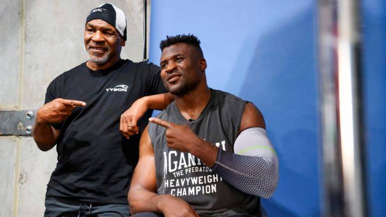 Former US boxer Mike Tyson (L) and Francis Ngannou pose for a photo after a training session at Ngannou’s gym in Las Vegas, Nevada, on September 26, 2022/AFPPix