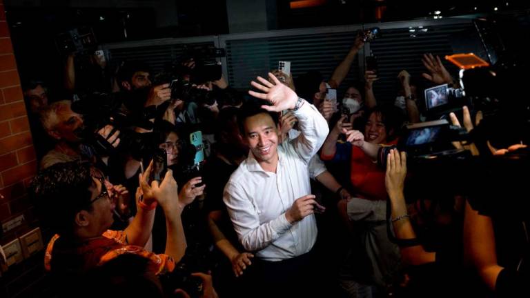Move Forward Party leader and prime ministerial candidate Pita Limjaroenrat (C) leaves the party’s headquarters as votes continue to be counted, during Thailand’s general election in Bangkok on May 14, 2023. AFPPIX