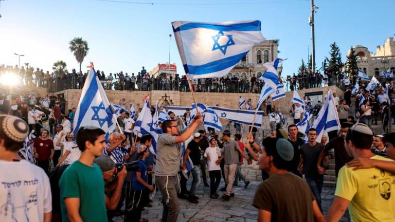 File photo: Israelis dance with flags by Damascus gate just outside Jerusalem's Old City June 15, 2021. REUTERSpix