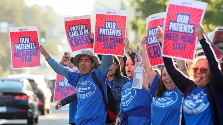 People hold placards, as a coalition of Kaiser Permanente Unions representing 75,000 healthcare workers at Kaiser Permanente start a three day strike across the United States over a new contract, in San Diego, California, U.S. October 4, 2023/REUTERSPix