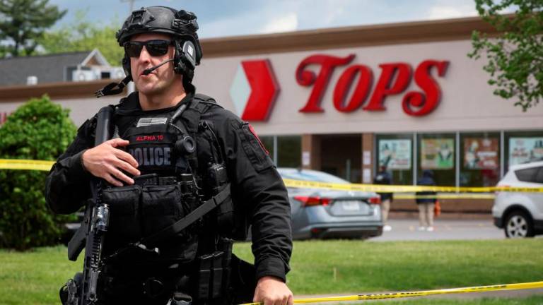 A Buffalo Police officer works at the scene of a shooting at a Tops supermarket in Buffalo, New York, U.S. May 17, 2022. REUTERSPIX