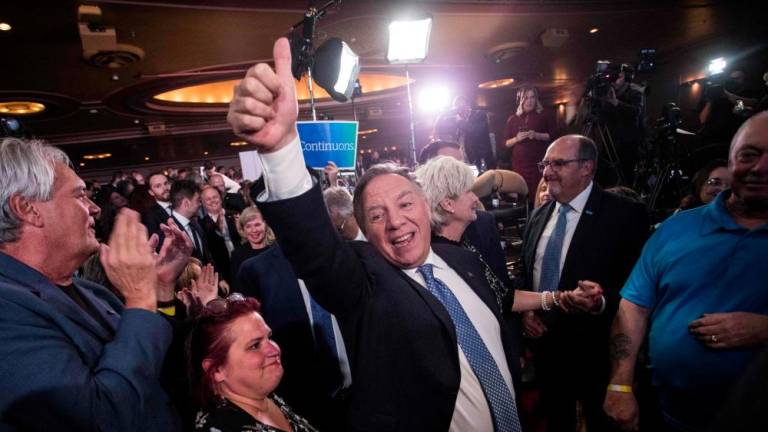 François Legault, leader of the Coalition Avenir Quebec, celebrates being reelected as Quebec Prime Minister at the Capitole theater in Quebec City after Quebec's provincial elections on October 3, 2022. - AFPPIX