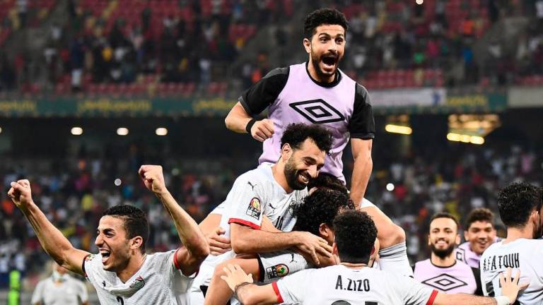 TOPSHOT - Egypt’s forward Mohamed Salah (C) celebrates with teammates after winning the Africa Cup of Nations (CAN) 2021 round of 16 football match between Ivory Coast and Egypt at Stade de Japoma in Douala on January 26, 2022. AFPPIX
