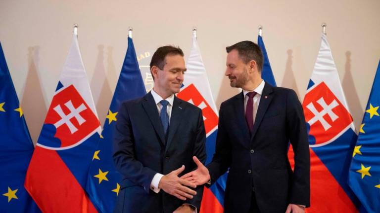 New Slovak Prime Minister Ludovit Odor (L) and leaving Prime Minister Eduard Heger shake hands at the Government’s office in Bratislava, Slovakia on May 15, 2023. AFPPIX