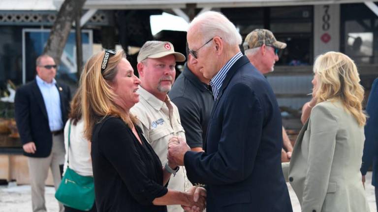 US President Joe Biden and US First Lady Jill Biden speak with local residents impacted by Hurricane Ian at Fisherman’s Pass in Fort Myers, Florida, on October 5, 2022. AFPPIX