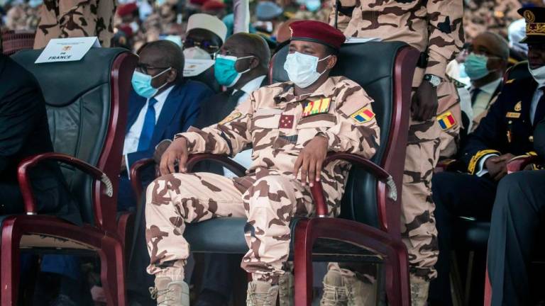(FILES) In this file photo taken on April 23, 2021 Mahamat Idriss Deby (C) sits in the honor tribune during the state funeral for his father Chadian president Idriss Deby in N'Djamena. - AFPPIX