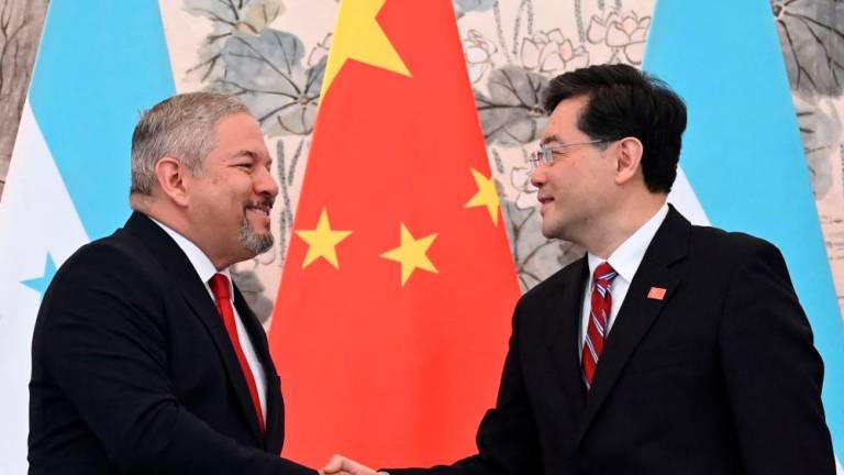 Honduras Foreign Minister Eduardo Enrique Reina (L) and Chinese Foreign Minister Qin Gang shake hands following the establishment of diplomatic relations between the two countries, during a joint statement after a ceremony in the Diaoyutai State Guesthouse in Beijing on March 26, 2023. AFPPIX