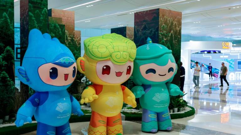 Hangzhou Asian Games official mascots named (from left) Chenchen, Congcong and Lianlian on showcase at the media center today/BERNAMApix