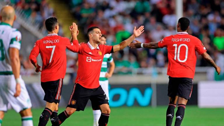 (L to R) Manchester United's Portuguese striker Cristiano Ronaldo, Manchester United's Portuguese defender Diogo Dalot, and Manchester United's English striker Marcus Rashford celebrate after a goal during the UEFA Europa League group E football match between Cyprus' Omonia Nicosia and England's Manchester United/AFPPIX