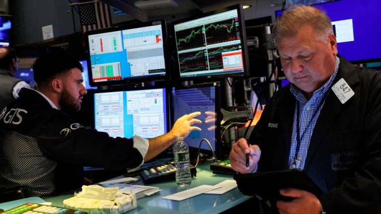 Traders work on the floor of the New York Stock Exchange on Monday, Aug 5. – Reuterspix