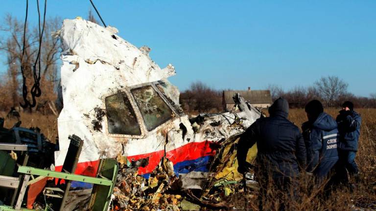 Local workers transport a piece of wreckage from Malaysia Airlines flight MH17 at the site of the plane crash near the village of Hrabove (Grabovo) in Donetsk region, eastern Ukraine November 20, 2014. REUTERSPIX
