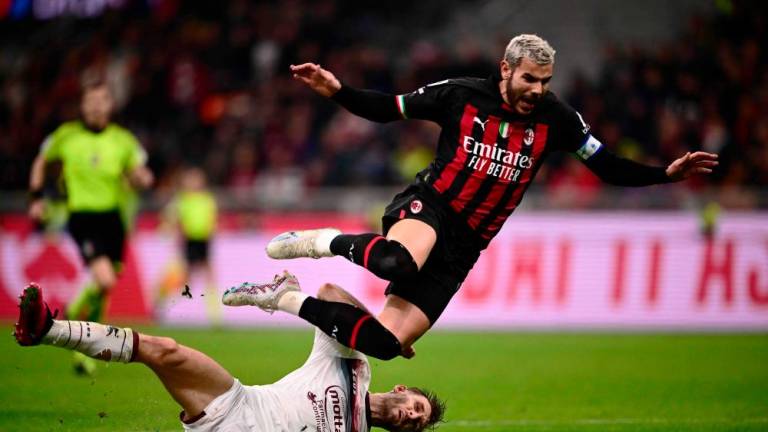 Salernitana’s Slovakian defender Norbert Gyomber (L) tackles AC Milan’s French defender Theo Hernandez during the Italian Serie A football match between AC Milan and US Salernitana 1919 at the San Siro stadium in Milan on March 13, 2023. AFPPIX