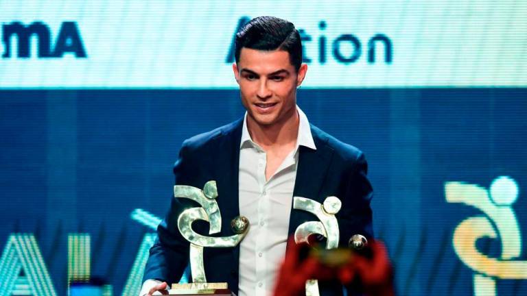 (FILES) In this file photo taken on December 02, 2019 Juventus’ Portuguese forward Cristiano Ronaldo receives the award of best player of the year of the Italian championship Serie A during the ‘Gran Gala del Calcio’ awards ceremony in Milan. US district judge, AFPPIX