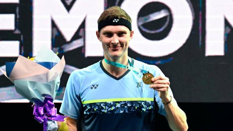 Denmark’s Viktor Axelsen poses with his gold medal after winning the men singles event at the Petronas Malaysia Open 2022 badminton tournament in Kuala Lumpur on July 3, 2022. AFPPIX
