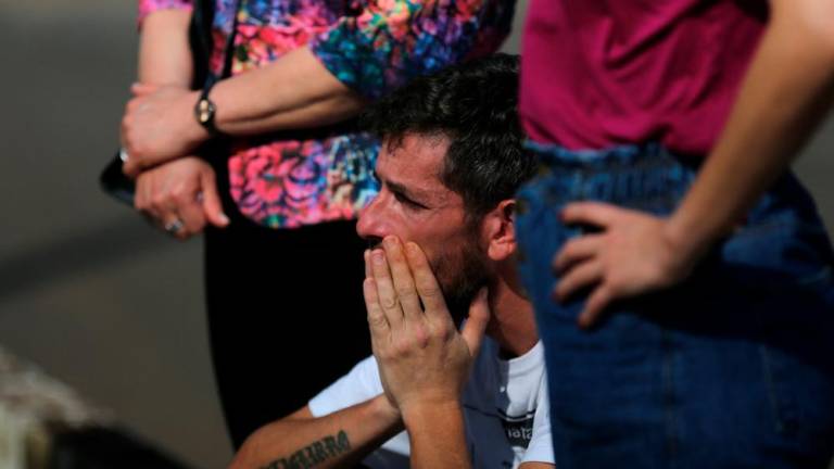 Flood survivor Miguel Rutigliano Bieleski cries during the funeral of his daughter Yasmin and his son Miguel Junior, fatal victims of the passage of the extratropical cyclone that hit the region, in Lajeado, Brazil September 11, 2023. -
