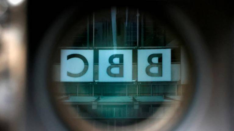 A BBC logo is reflected in the viewfinder of a television camera outside the British Broadcasting Corporation (BBC) headquarters in London, Britain, March 13, 2023/AFPPix