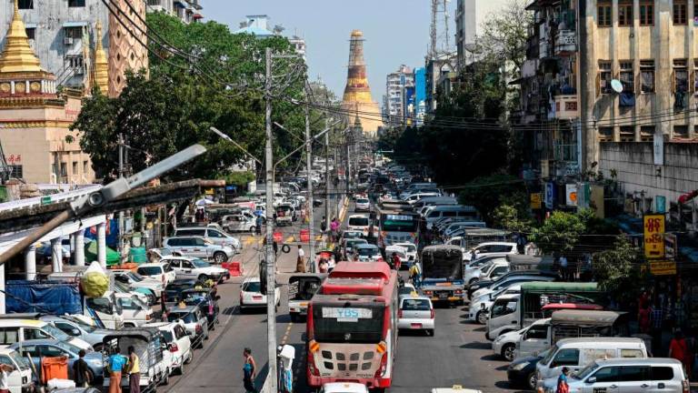 A general view shows traffic along Mahabandoola Road, with Sule Pagoda in the background, in Yangon on January 31, 2023/AFPPix