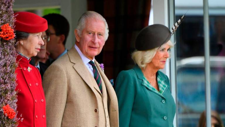 Britain's King Charles III (C), Britain's Queen Camilla (R) and Britain's Princess Anne, Princess Royal (L) attend the annual Braemar Gathering in Braemar, central Scotland, on September 2, 2023. AFPPIX