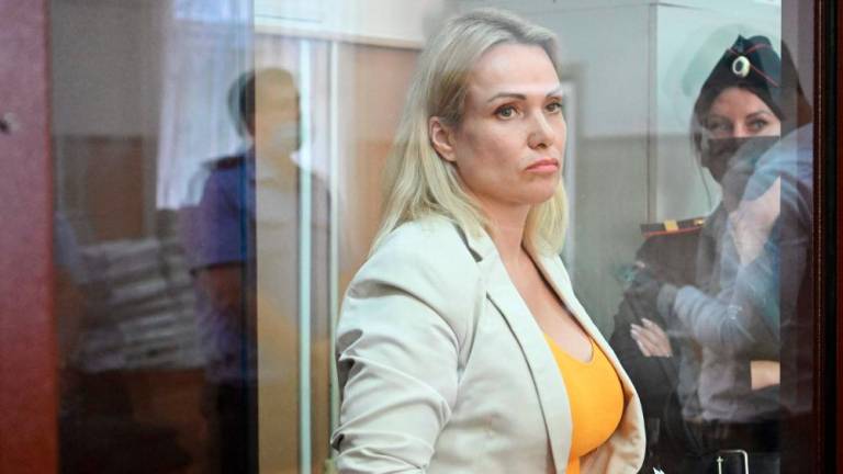 A Russian court on August 11 placed former state TV journalist Marina Ovsyannikova, who denounced President Vladimir Putin's intervention in Ukraine live on air, under house arrest until October. AFPPIX