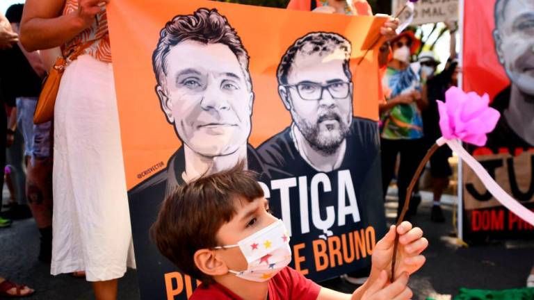 Filepix: A child holds a flower during a protest in demand of justice for the killing of British journalist Dom Phillips and Brazilian indigenist Bruno Pereira, in Brasilia, on June 19, 2022/AFPPix