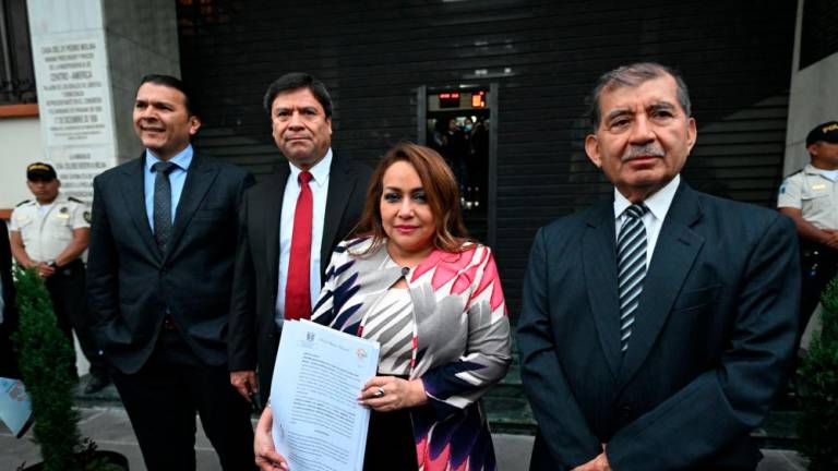 The Supreme Electoral Tribunal’s President, Irma Palencia (C), accompanied by magistrates Gabriel Aguilera (1-L), Ranulfo Rojas (2-L), and Mynor Franco, pose for pictures outside the headquarters of the Constitutional Court in Guatemala City on September 29, 2023. AFPPIX