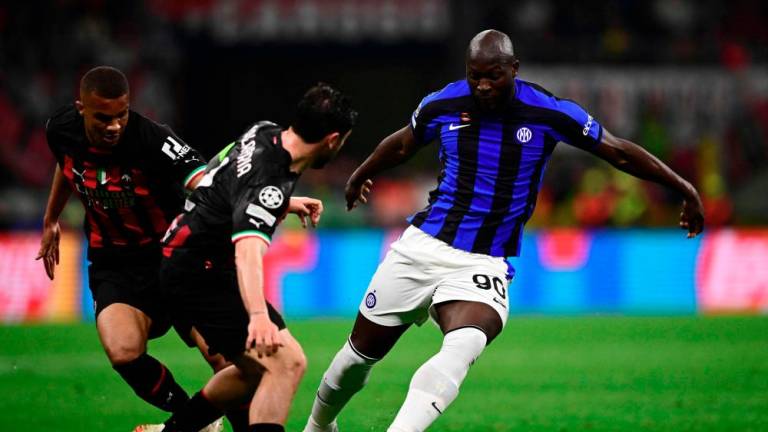 Romelu Lukaku (R) challenges Malick Thiaw (L) and Davide Calabria during the UEFA Champions League semi-final first leg football match between AC Milan and Inter Milan, on May 10, 2023 at the San Siro stadium in Milan. AFPPIX