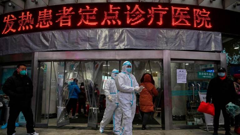 This file photo taken January 25, 2020 shows medical staff members, wearing protective clothing at the Wuhan Red Cross Hospital in Wuhan, as the city struggled with the outbreak of the once-mysterious virus which eventually killed millions globally. AFPPIX