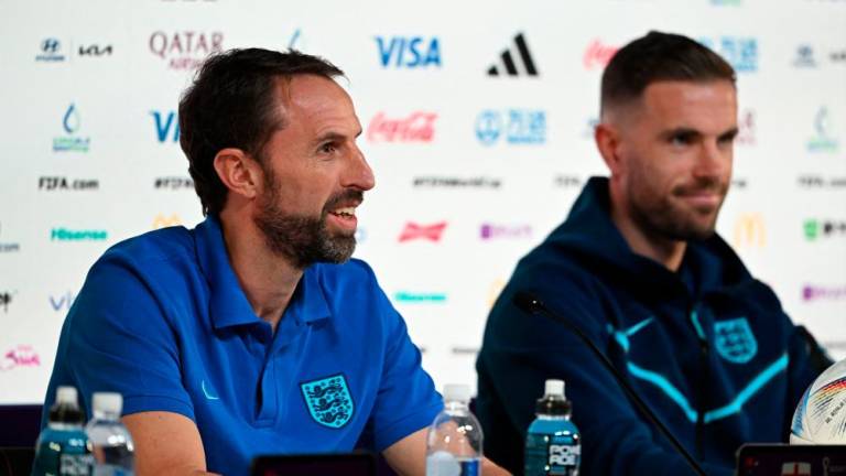 England’s coach Gareth Southgate (L) and England’s midfielder Jordan Henderson give a press conference at the Qatar National Convention Center (QNCC) in Doha on November 28, 2022, on the eve of the Qatar 2022 World Cup football match between Wales and England. AFPPIX