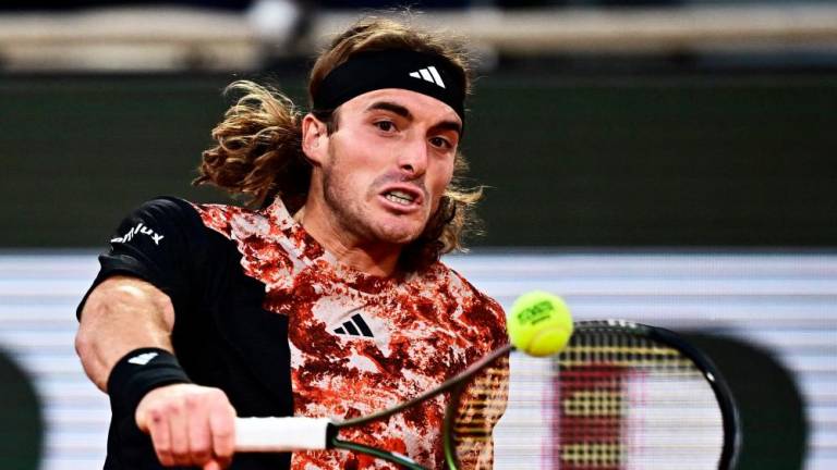 Greece’s Stefanos Tsitsipas plays a backhand return to Spain’s Carlos Alcaraz Garfia during their men’s singles quarter final match on day ten of the Roland-Garros Open tennis tournament at the Court Philippe-Chatrier in Paris on June 6, 2023. AFPPIX