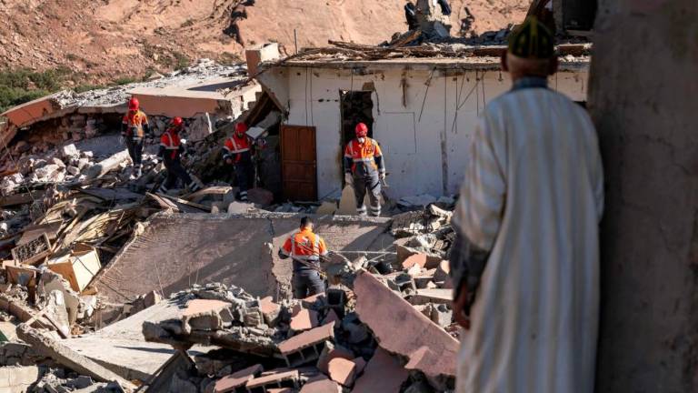 TOPSHOT - Volunteers search for survivors in the rubble in the village of Talat N'Yacoub, south of Marrakech on September 11, 2023. The quake killed at least 2,122 people, injured more than 2,400 others, and flattened entire villages. - AFPPIX