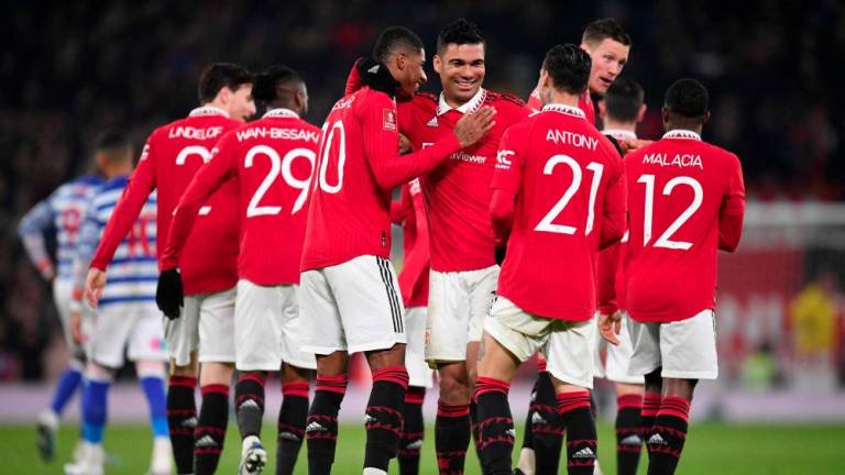Manchester United's Brazilian midfielder Casemiro (C) celebrates with teammates after scoring their second goal during the English FA Cup fourth round football match between Manchester United and Reading at Old Trafford in Manchester, north west England, on January 28, 2023. - AFPPIX