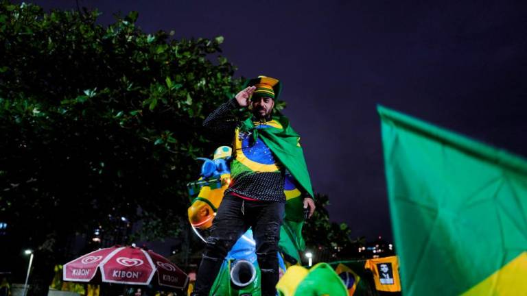 A supporter of Brazil's President Jair Bolsonaro gestures while gathering with fellow supporters outside Bolsonaro's home, in Rio de Janeiro, Brazil October 2, 2022. - REUTERSPIX