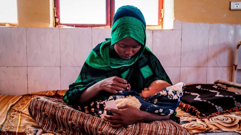 A woman holds a malnourished child at the nutrition unit of the Gode General Hospital, in the city of Gode, Ethiopia, on January 13, 2023/AFPPix